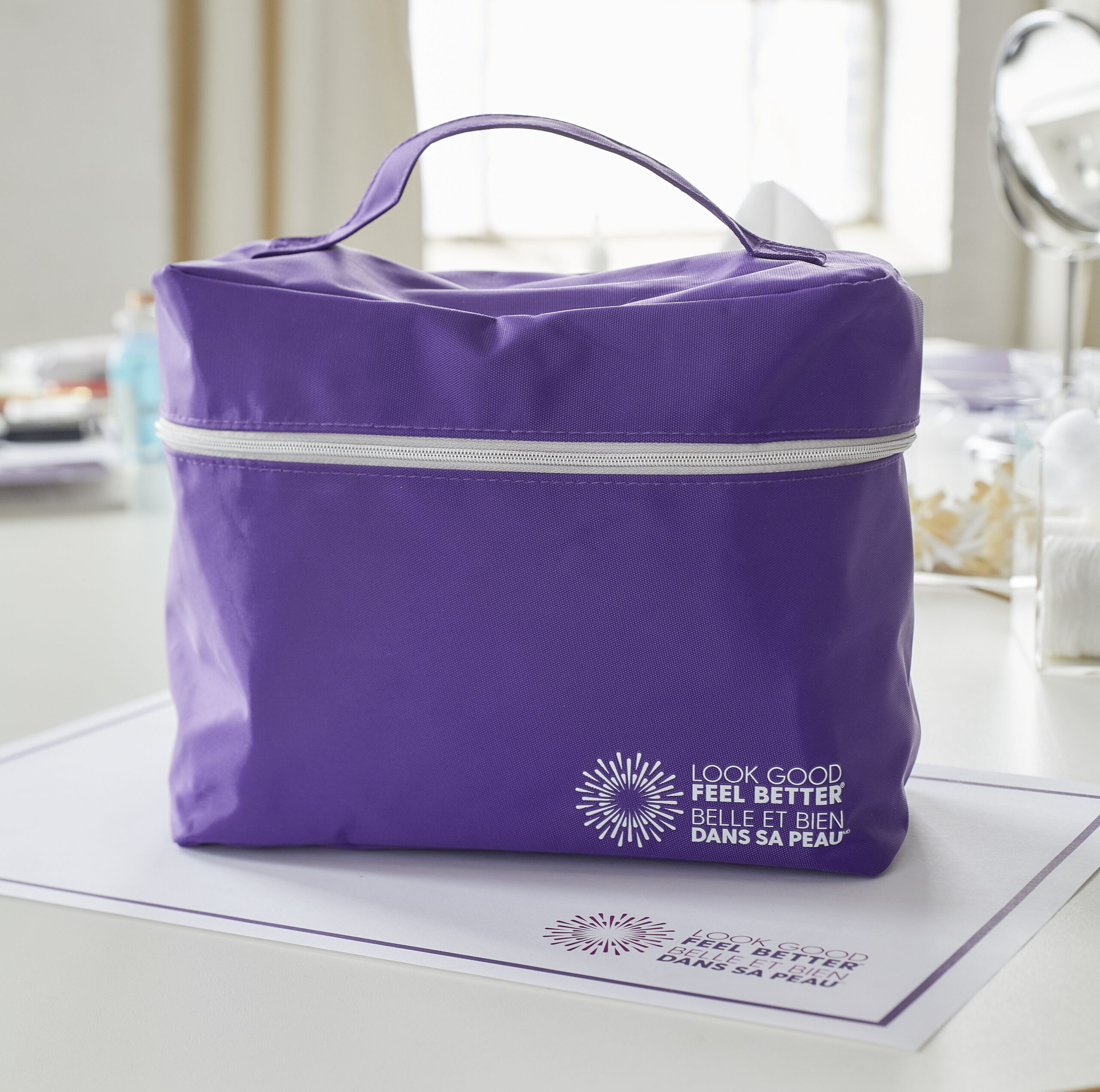 Purple cosmetics bag on a table with the Look Good Feel Better logo in the bottom-right corner.