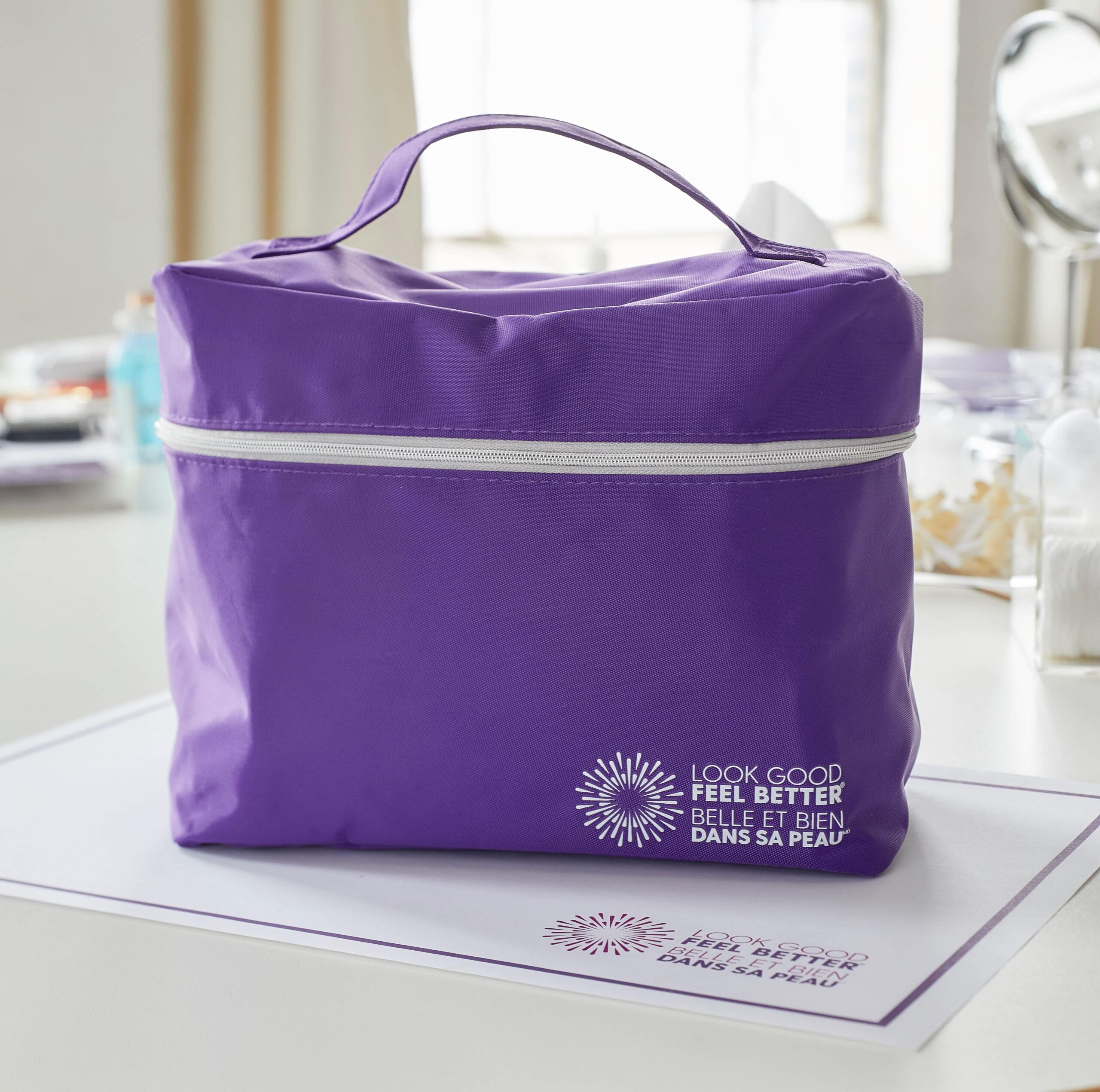 Purple cosmetics bag on a table with the Look Good Feel Better logo in the bottom-right corner.