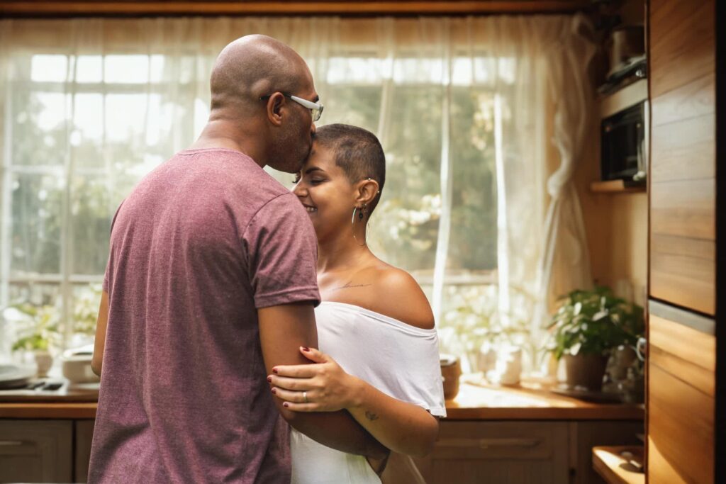 A couple in a kitchen embracing each other.