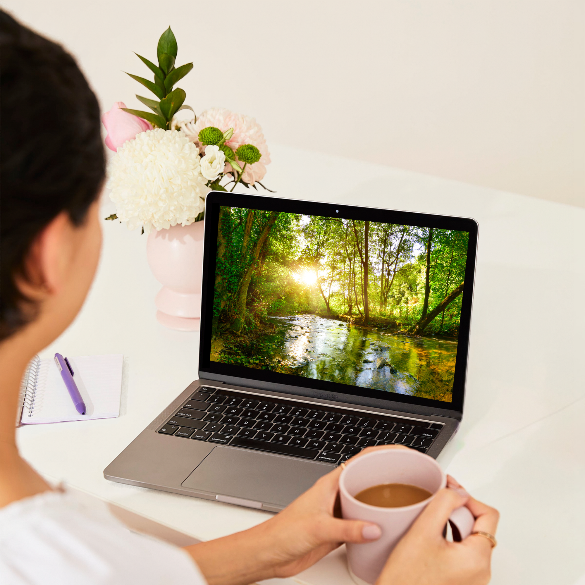 A woman watching a webinar on mindfulness meditation.